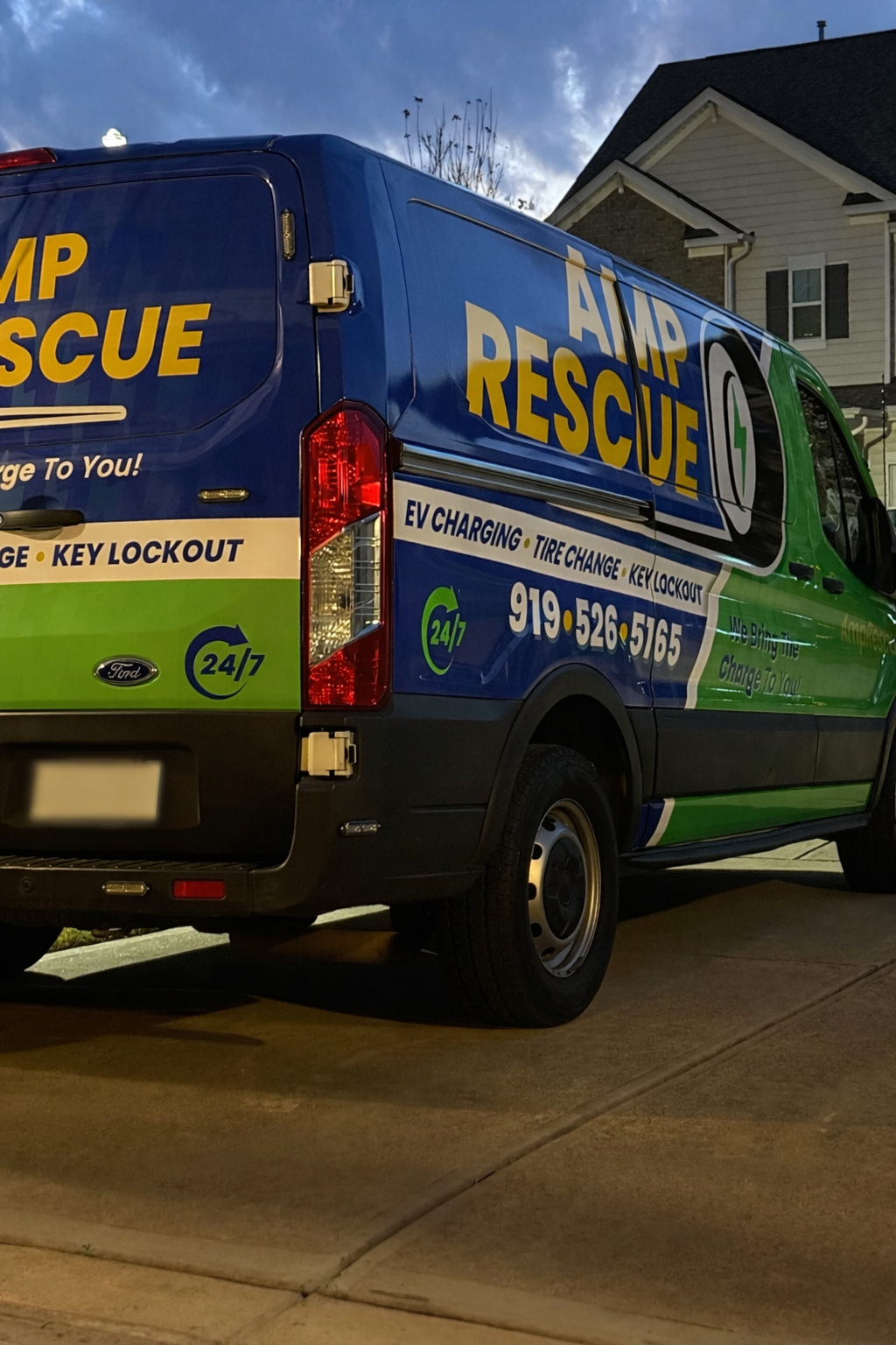 Amp Rescue mobile roadside assistance van in a driveway