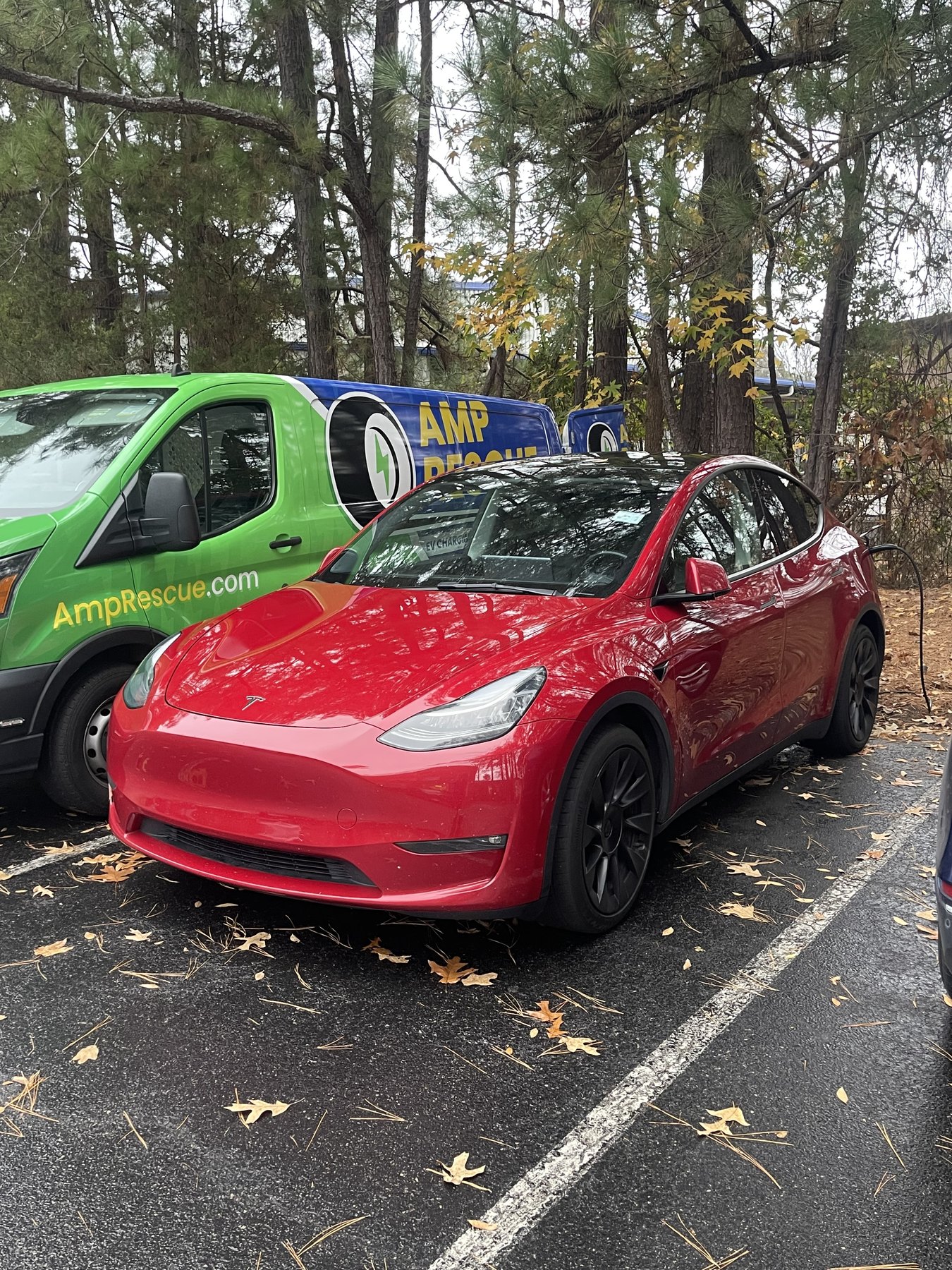 Amp Rescue mobile EV charging van providing roadside charging support to a Tesla