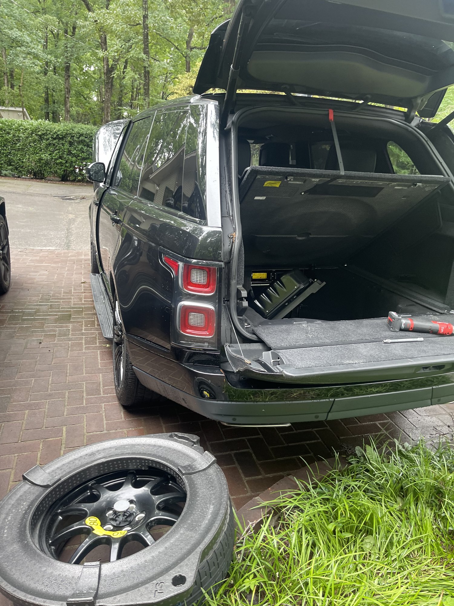 Range Rover prepared for mobile tire service with the spare wheel ready